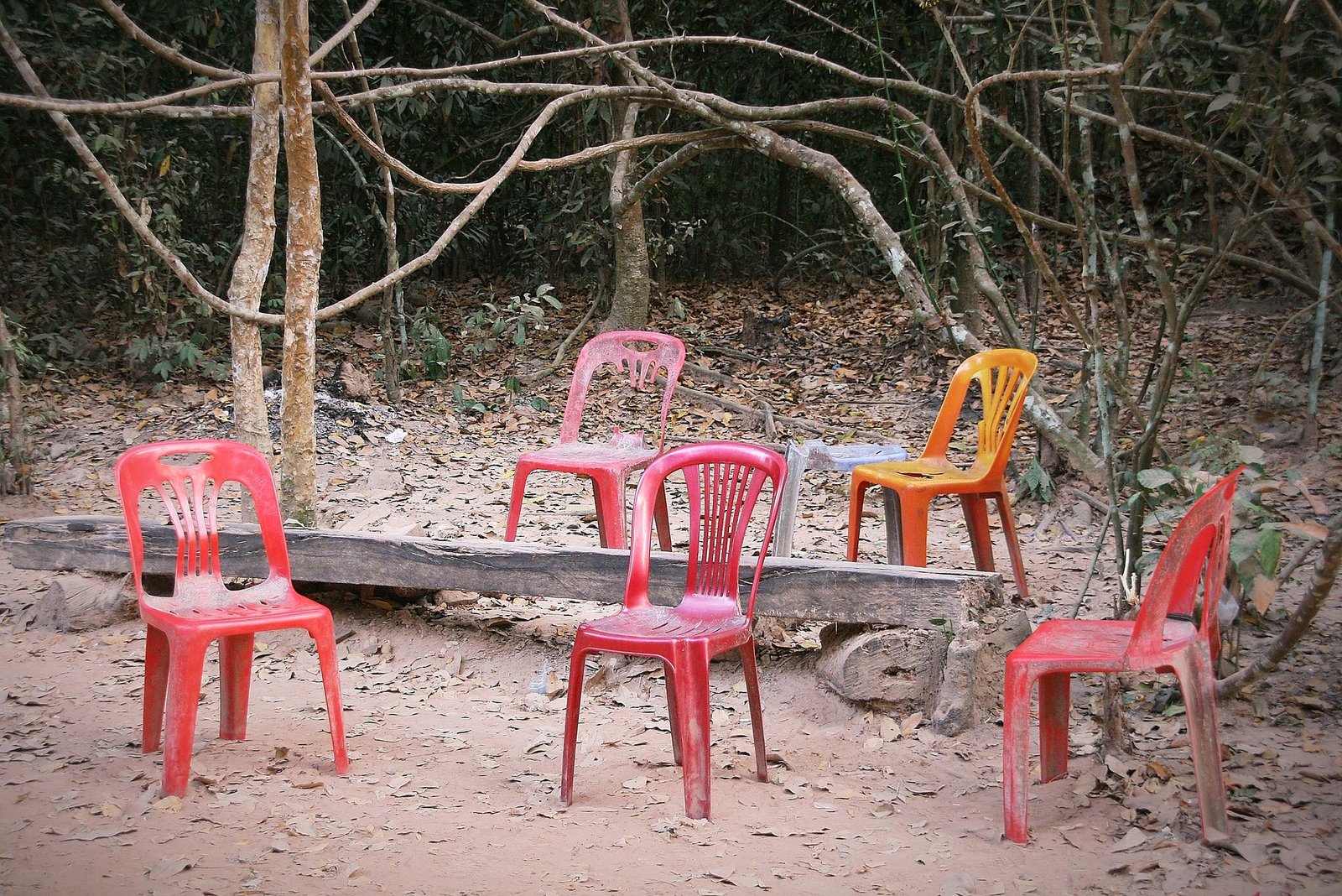 A circle of mostly empty plastic chairs after a meeting